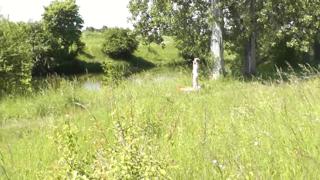 Sexy milf sunbathing nude; random guy watches outdoors